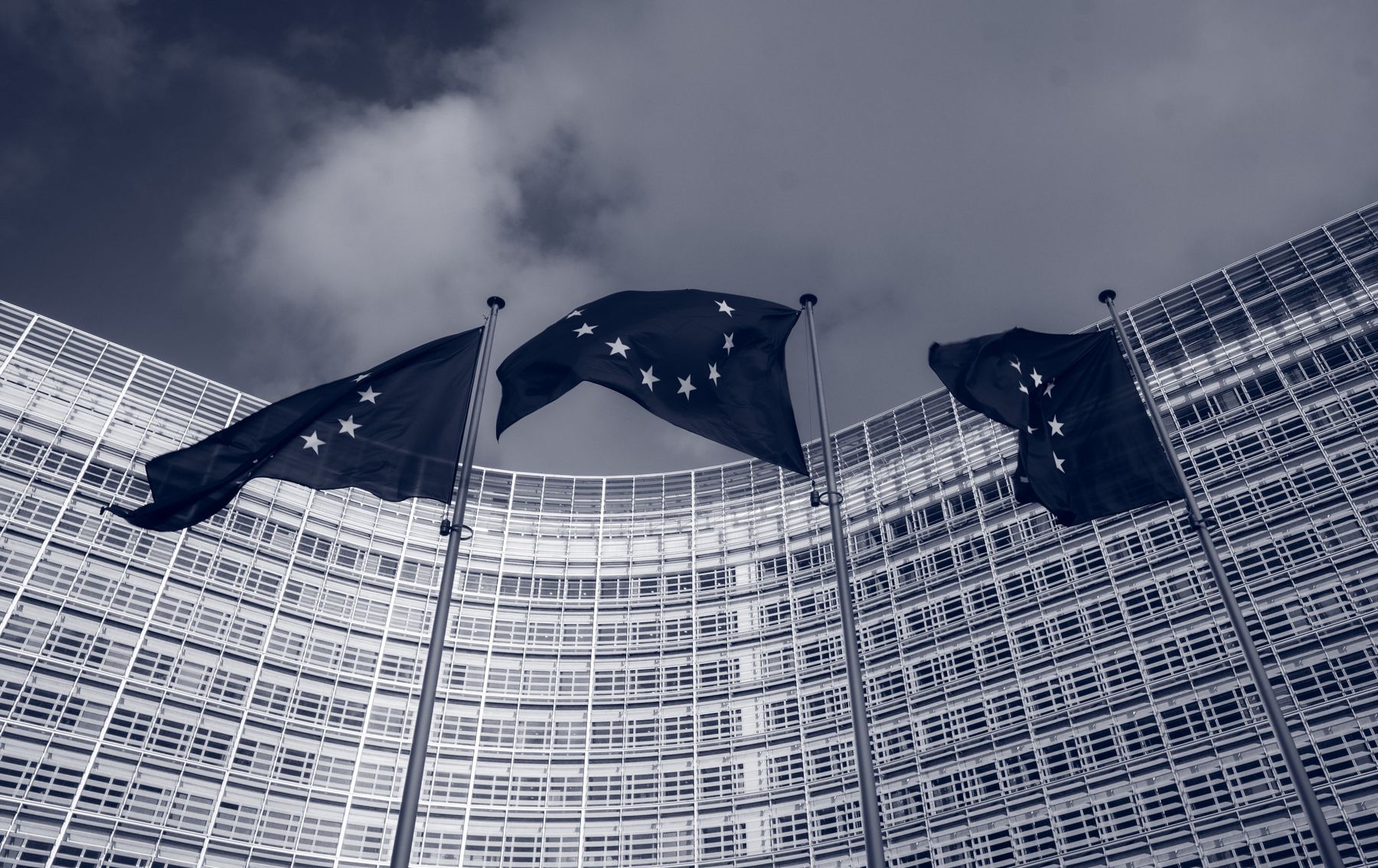 Flags of the European Union in front of the EU-commission building “Berlaymont” in Brussels, Belgium