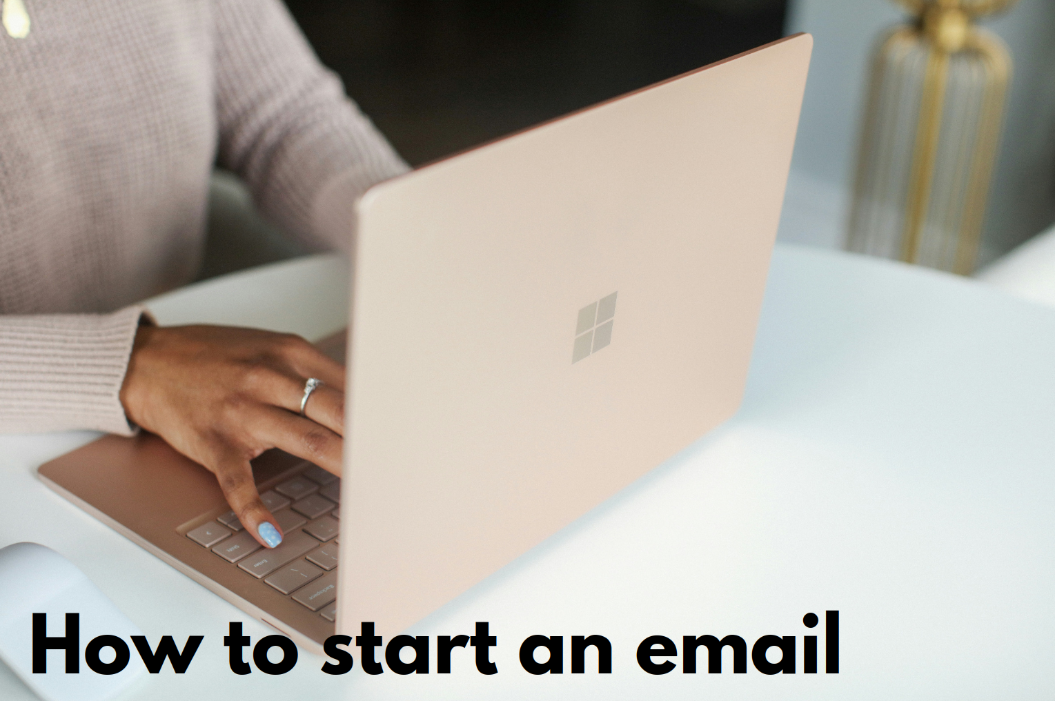 Woman typing on a laptop: How to start an email